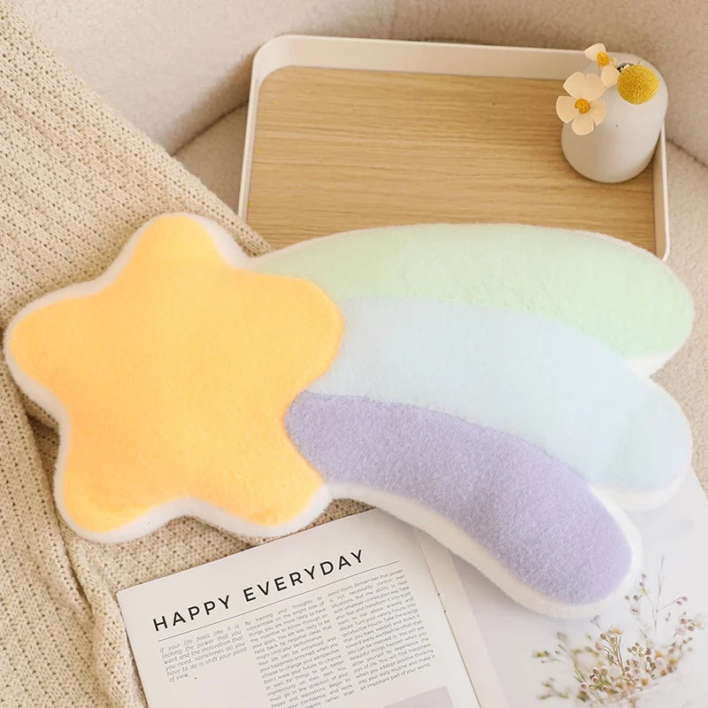 Star-shaped kawaii pillow with a gradient of yellow to purple on a table with a magazine underneath.