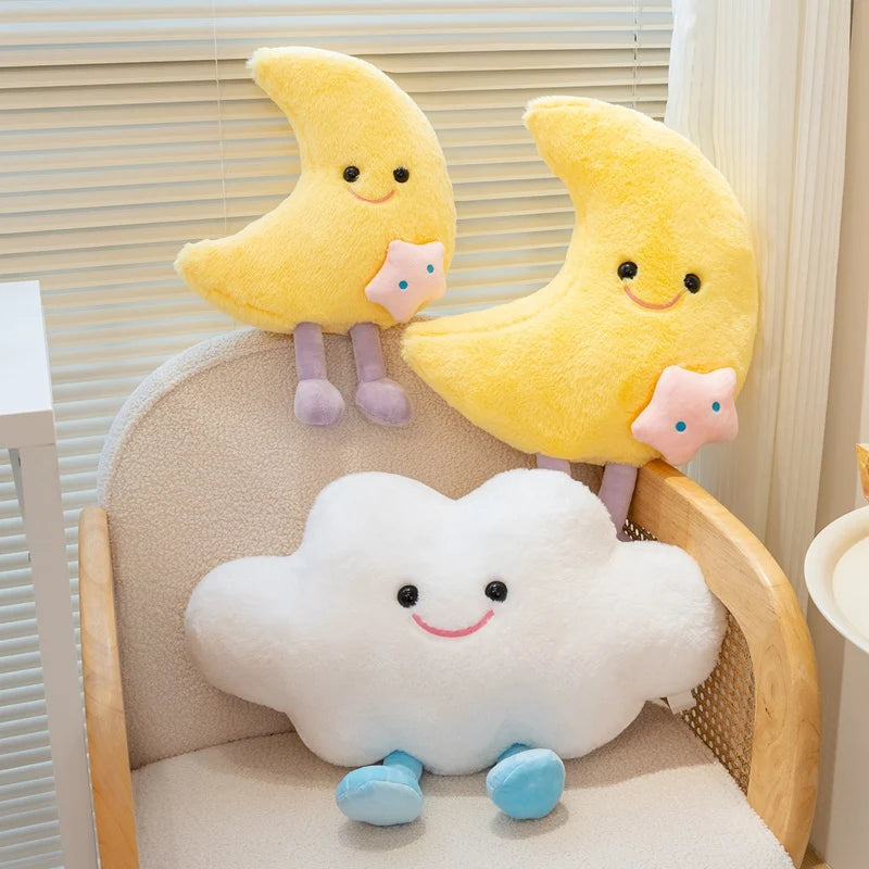 Two yellow crescent moon kawaii plush toys and one white cloud plush toy on a chair.