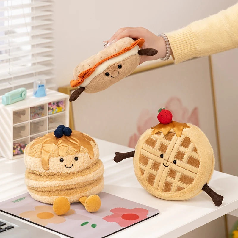 Plush kawaii toys shaped like a sandwich, donut, and waffle on a table.