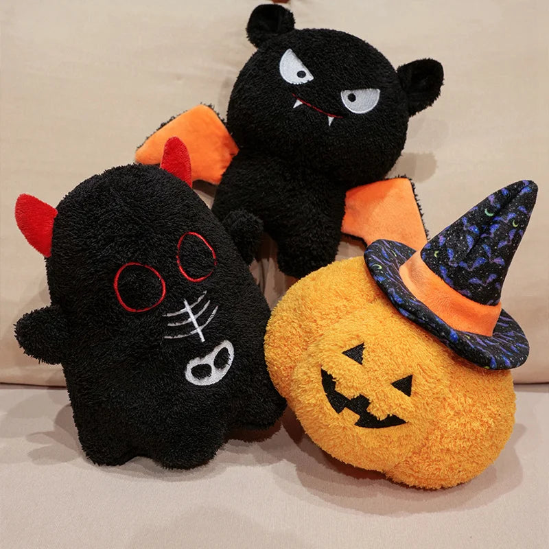 Three Halloween-themed plush kawaii toys on a beige background