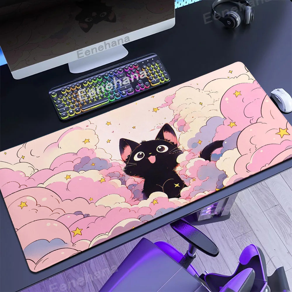 Desk setup with a large mouse pad featuring a Kawaii black cat design, keyboard, and monitor.