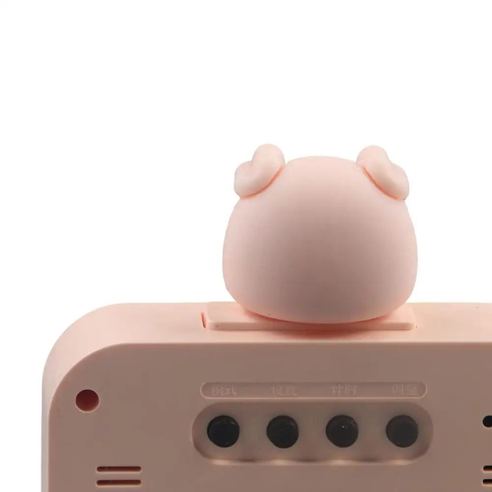 Pink electronic device with a cute kawaii animal-shaped button on a white background