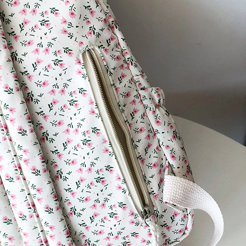 Kawaii floral-patterned backpack with a zipper on a white surface