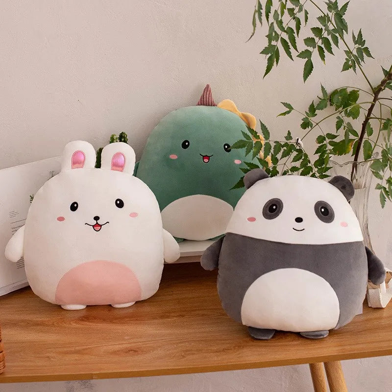 Three cute kawaii plush toys on a wooden surface with a plant in the background
