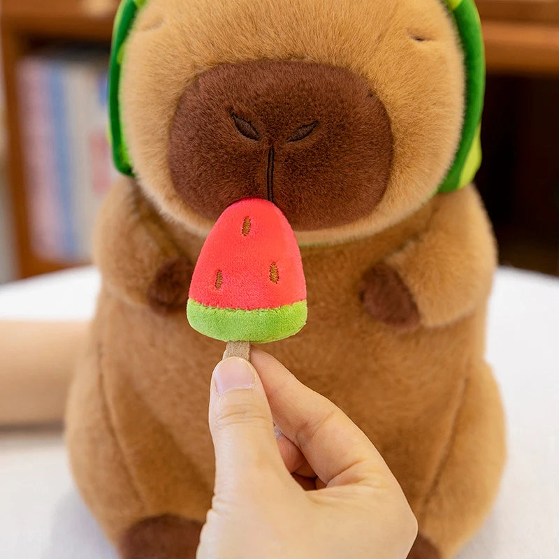 Kawaii plush toy dog with a watermelon popsicle held by a hand against a blurred bookshelf background