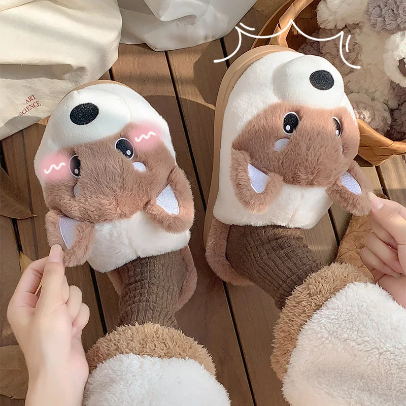 Pair of kawaii cartoon sloth slippers held by a person on a wooden floor.