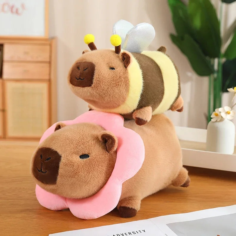Two kawaii plush toys resembling a bee and a flower on a wooden surface.