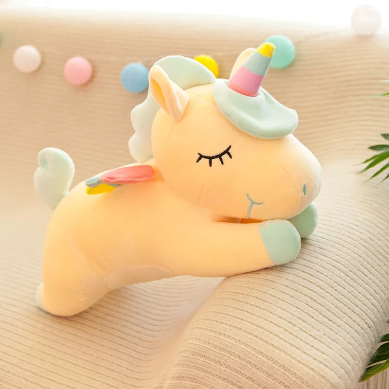 Cute unicorn plush kawaii toy on a soft surface with pastel decorations.