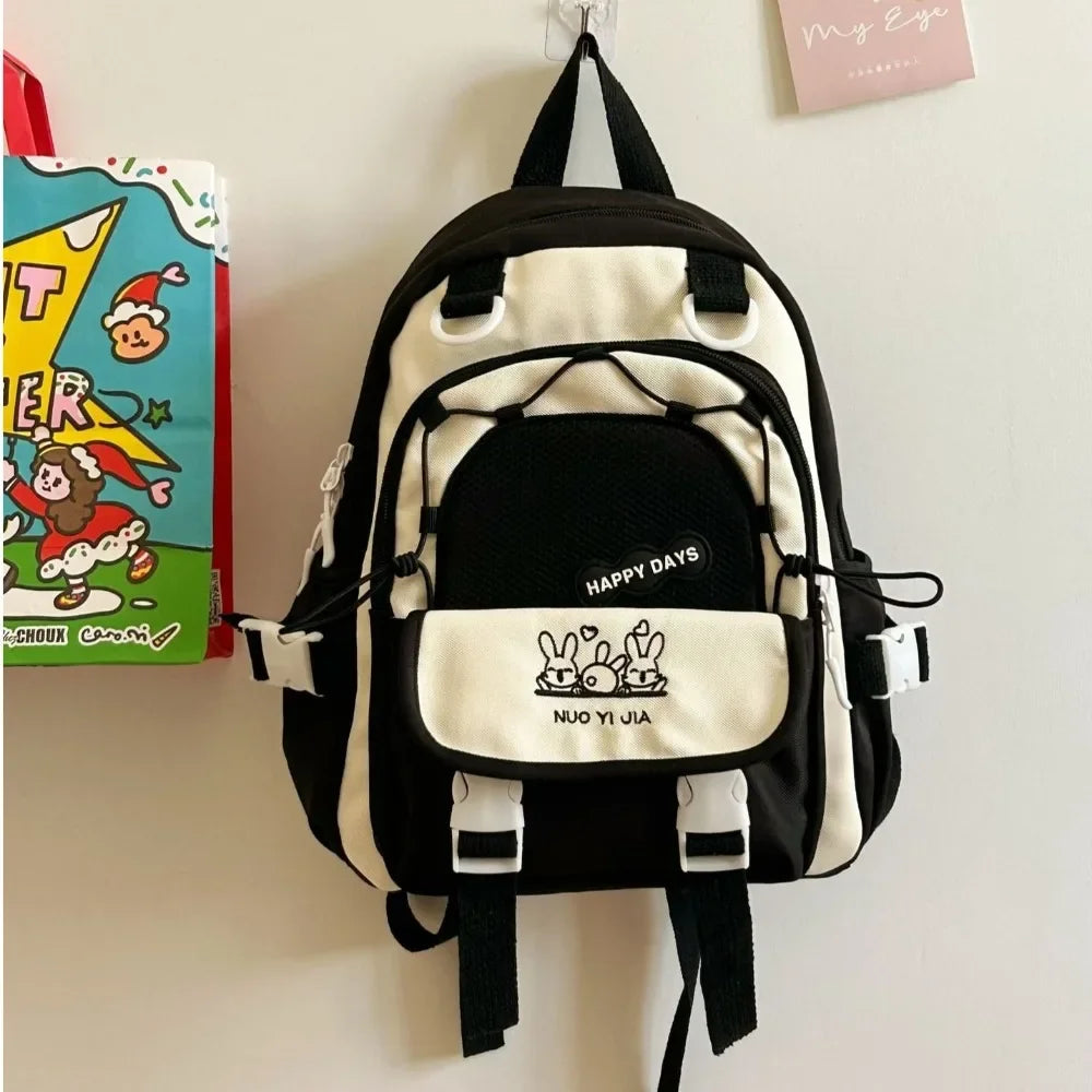 Kawaii black and white backpack with visible branding on a plain background