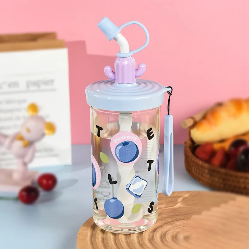 Clear water bottle with colorful Kawaii designs and a purple lid on a wooden surface.