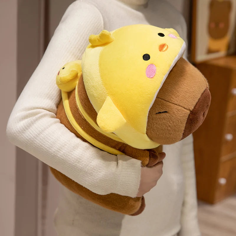 Person holding a kawaii plush toy with a yellow face and brown body.