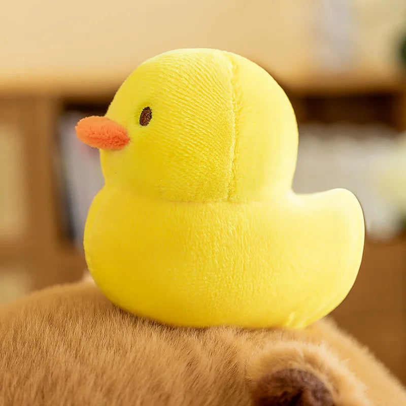 Yellow kawaii plush duck toy on a dog's back with a blurred background
