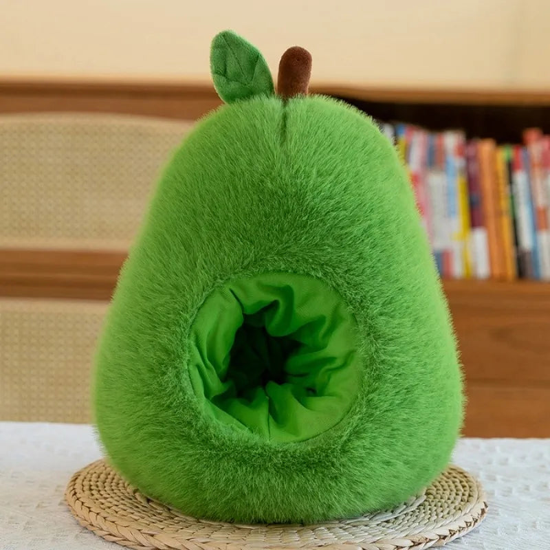 Green kawaii plush avocado-shaped pillow on a woven mat with books in the background
