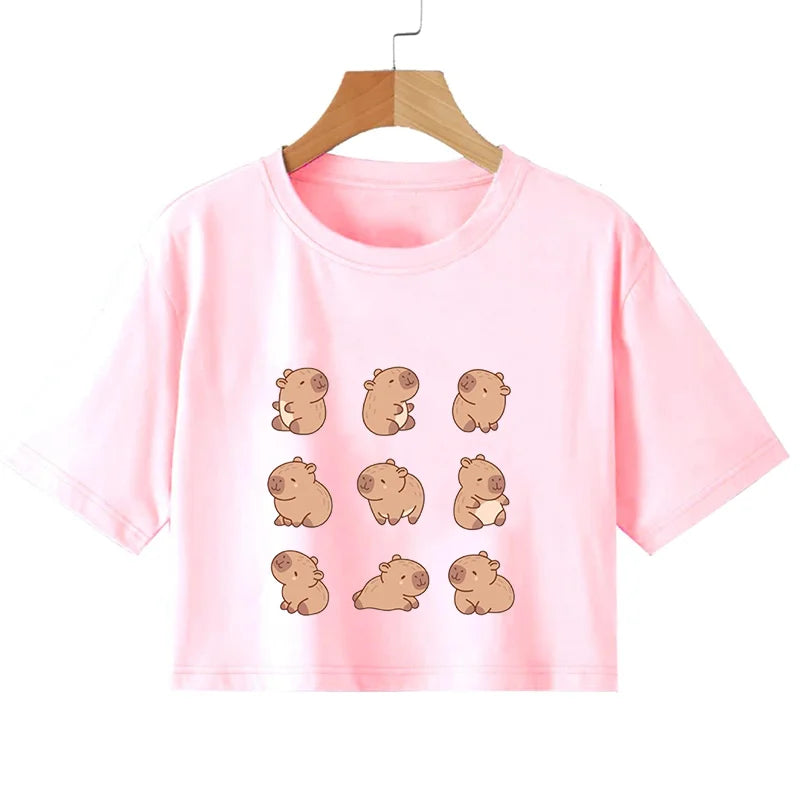 Pink t-shirt with kawaii cartoon guinea pig designs on a hanger against a white background