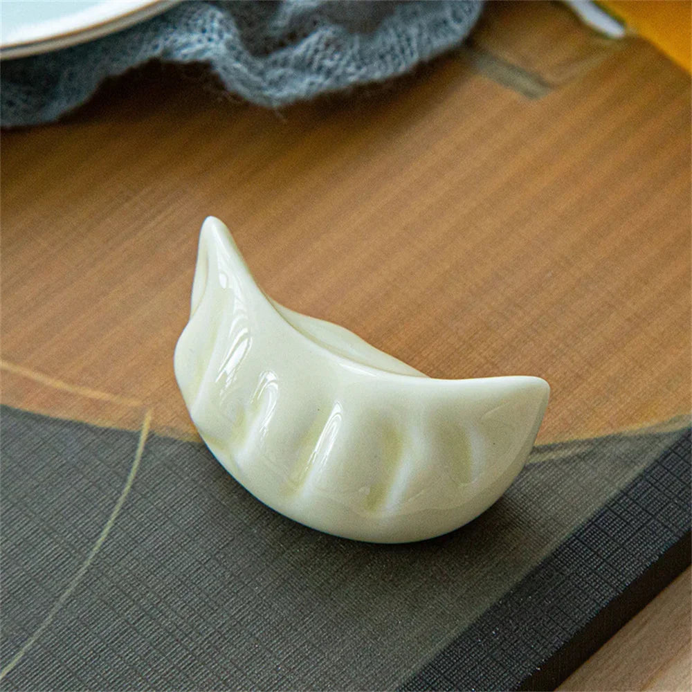 White ceramic kawaii dumpling on a wooden surface