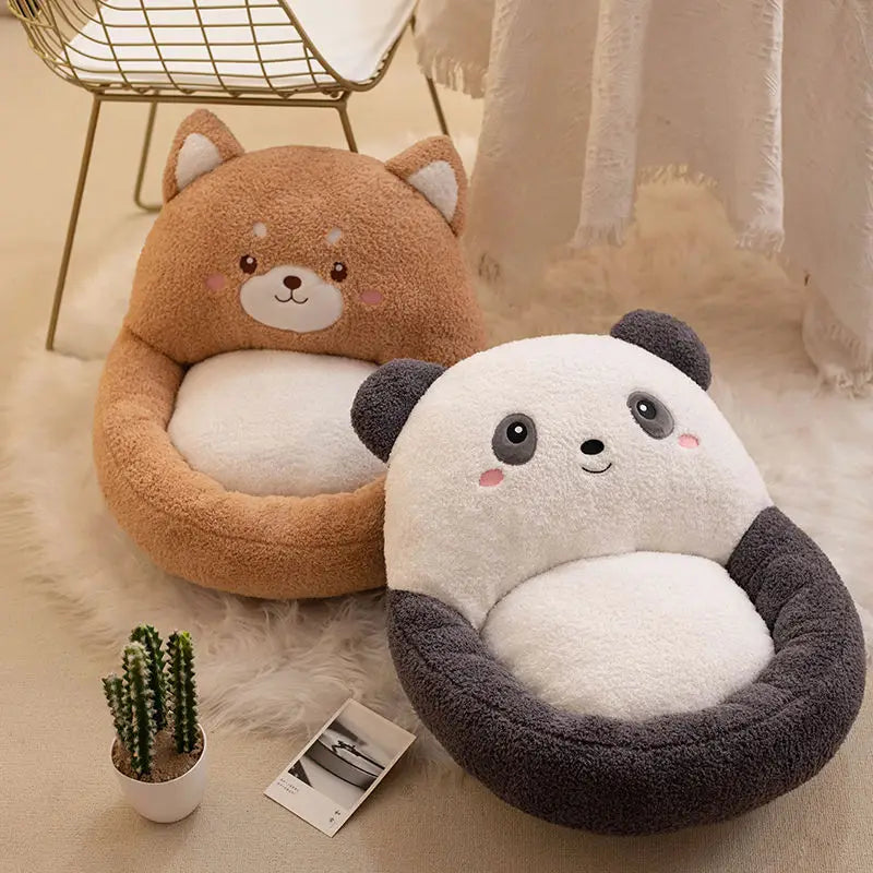 Two cute animal-shaped kawaii cushions, one brown and one panda, on a soft surface with a plant and photo in the background.