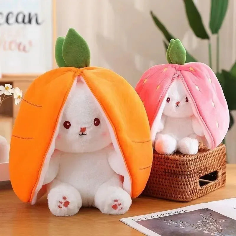 Two plush kawaii toys shaped like bunnies inside carrot and peach shells on a wooden surface.
