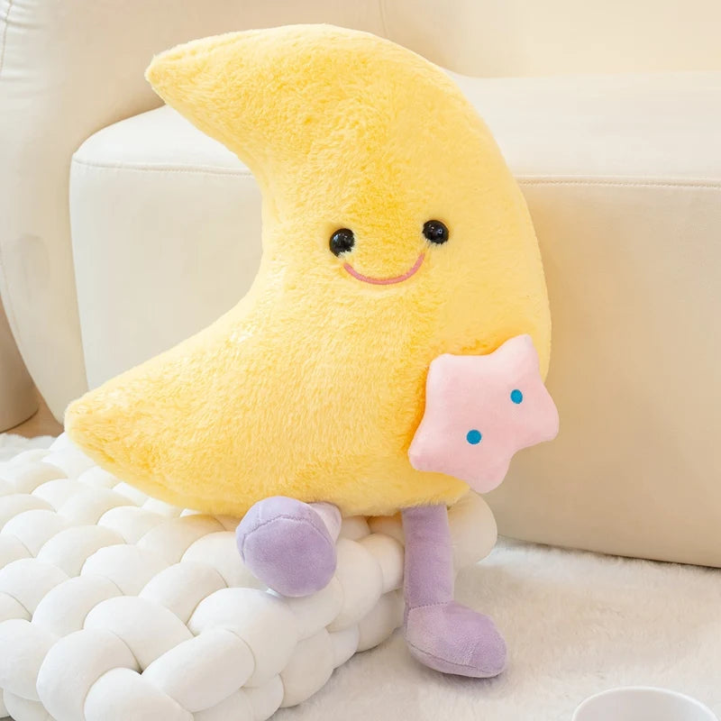 Kawaii plush toy shaped like a yellow moon with a smiling face on a white surface.