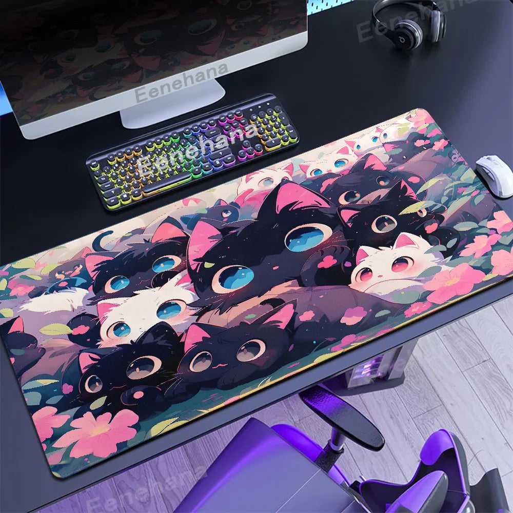 Desk setup with a colorful Kawaii black cat-themed mouse pad, keyboard, and monitor.