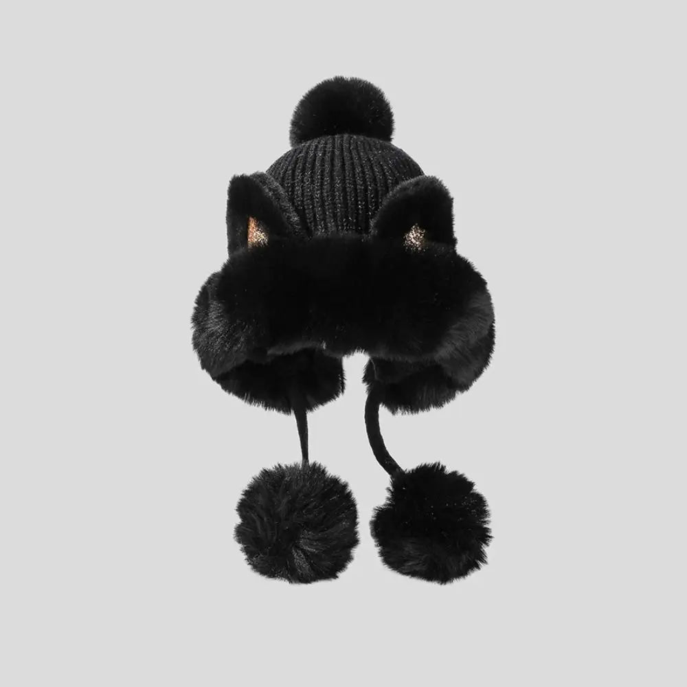 Black Kawaii knitted hat with pom-poms on a light gray background