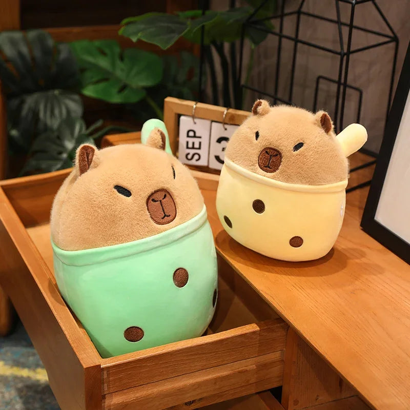 Two cute kawaii animal-shaped plushies on a wooden surface with a plant in the background.