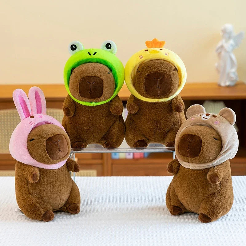 Four brown kawaii plush toys with colorful hats on a white surface.