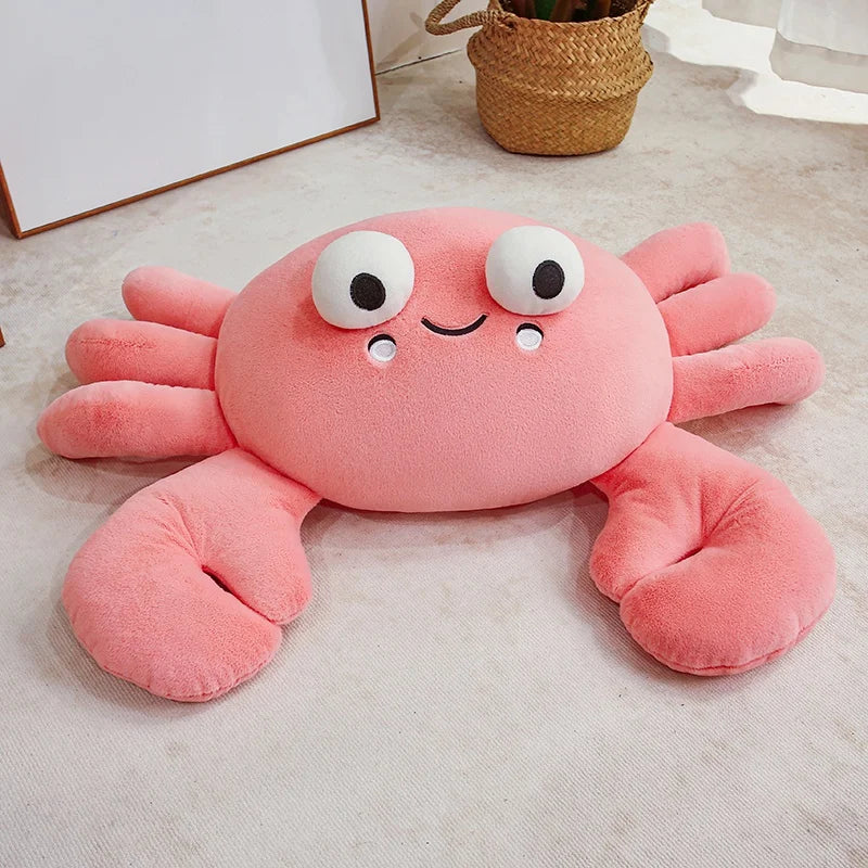 Pink crab-shaped kawaii plush toy on a light-colored floor.