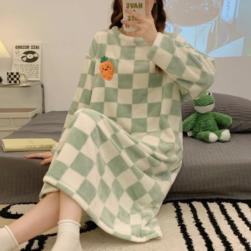 Person wearing a green and white checkered kawaii robe sitting on a couch with a plush toy.