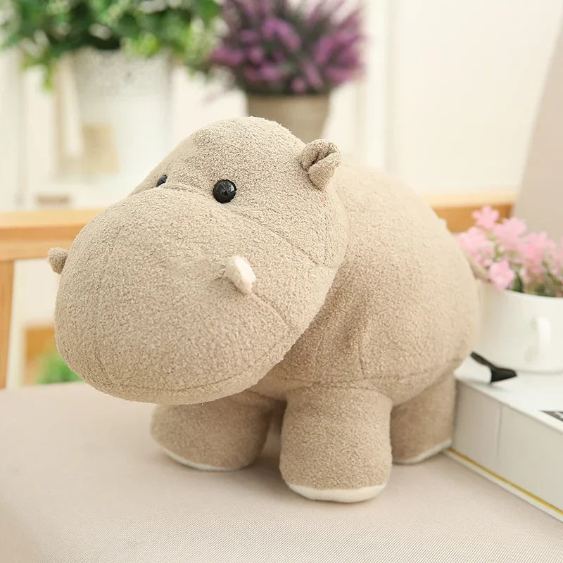 Kawaii plush hippo toy on a light surface with a blurred indoor background