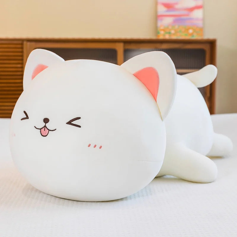 Cute white kawaii cat-shaped plush toy with pink ears on a light surface.