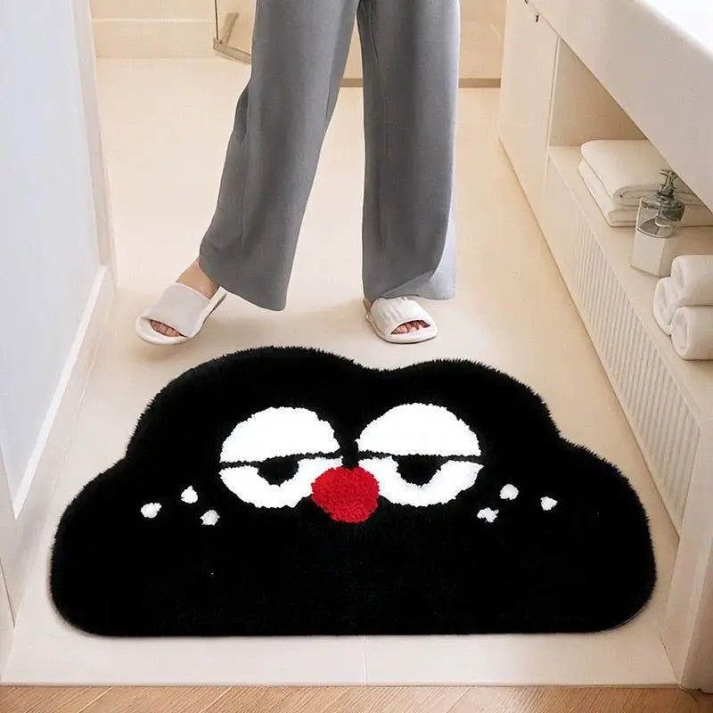 Black Kawaii cloud-shaped rug with cartoon face design on a bathroom floor.