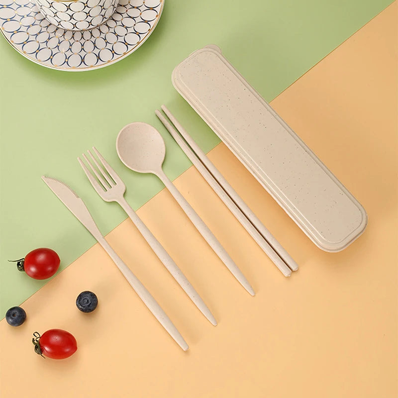 Set of bamboo kawaii cutlery including knife, fork, spoon, and chopsticks with a carrying case on a green and beige background.