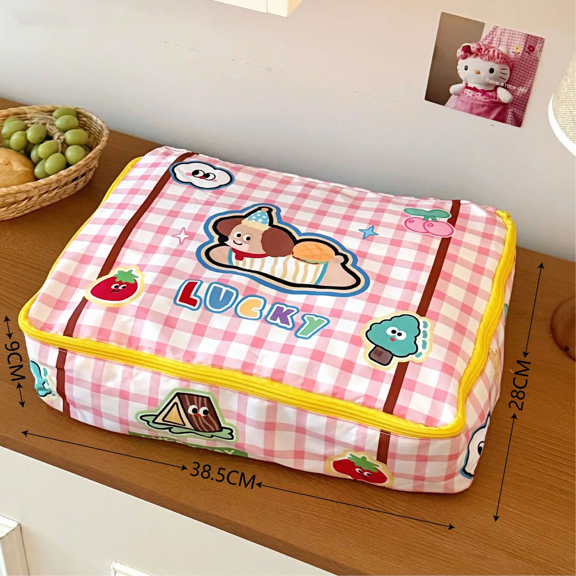 Pink checkered pouch with Kawaii cartoon design and 'LUCKY' text on a wooden surface
