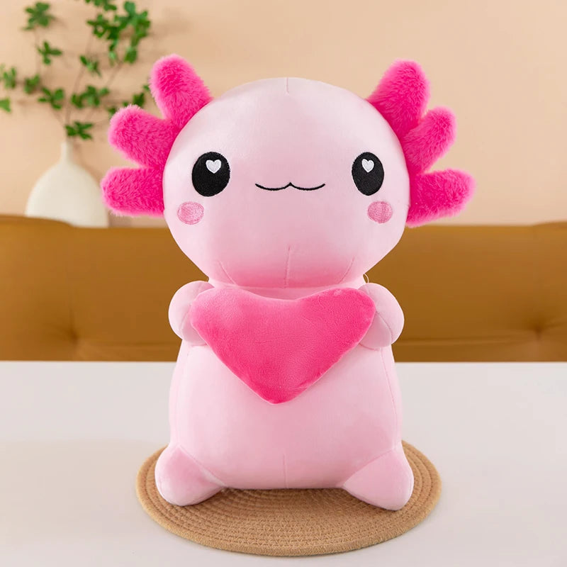 Pink axolotl kawaii plush toy with a heart on a beige background