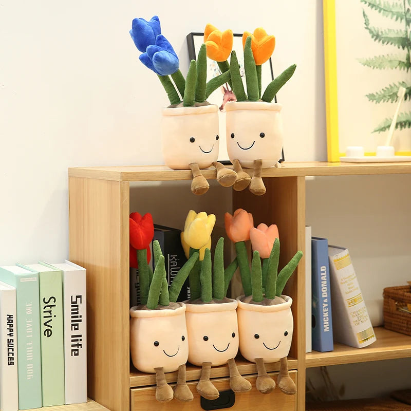 Plush tulips in decorative pots with kawaii smiling faces on a wooden shelf.