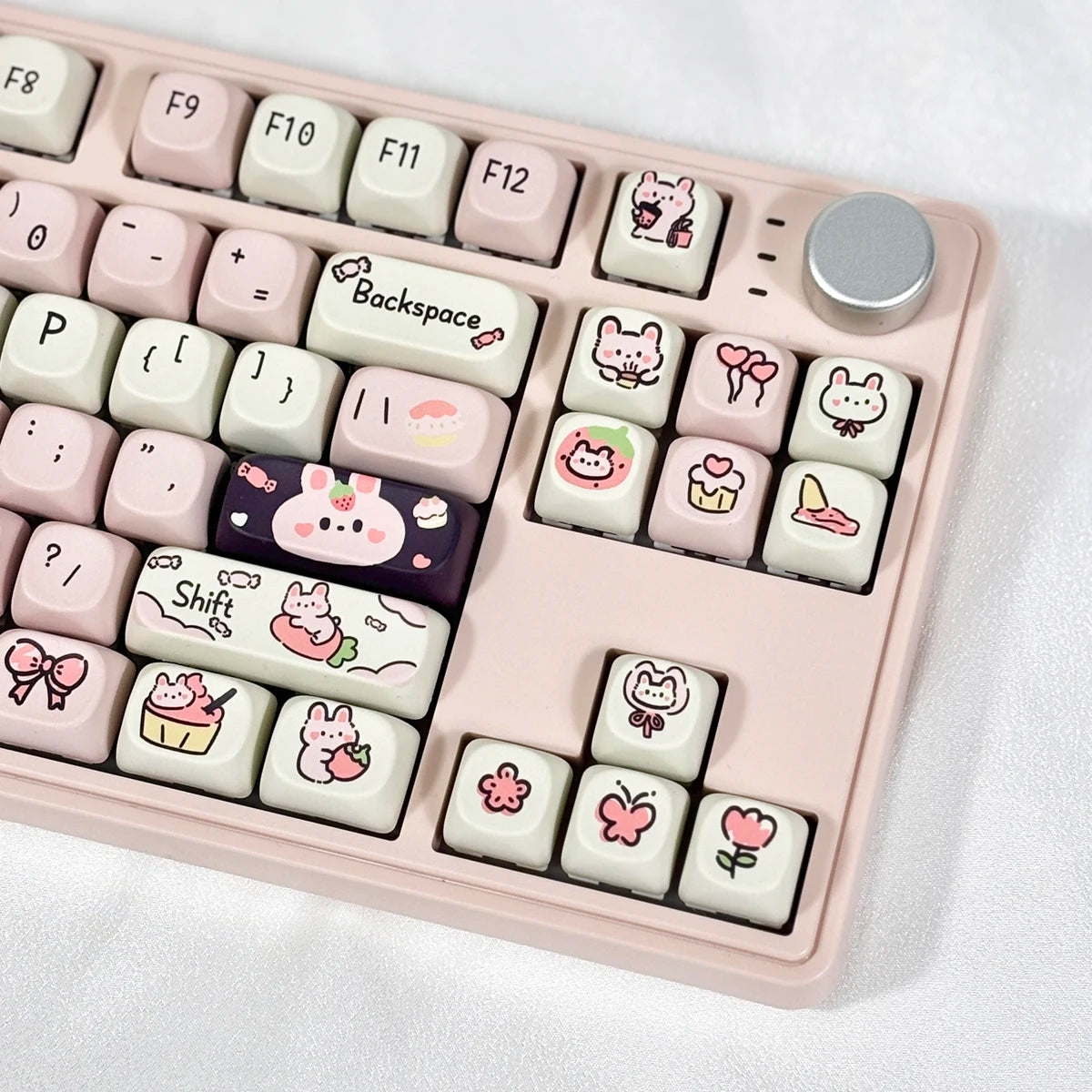 Keyboard with Kawaii cartoon character keycaps on a white background