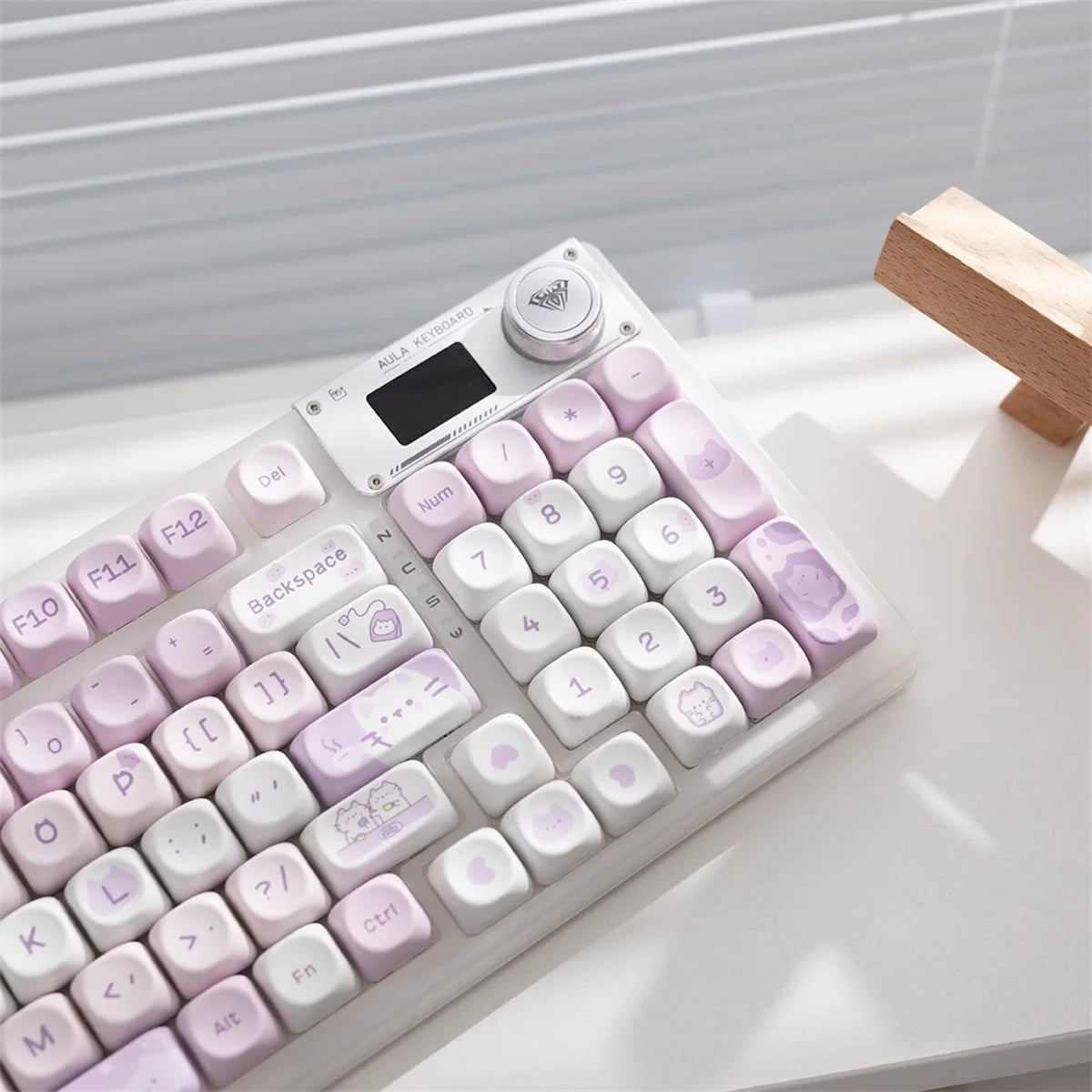 Kawaii keyboard with pink and white keys on a light surface