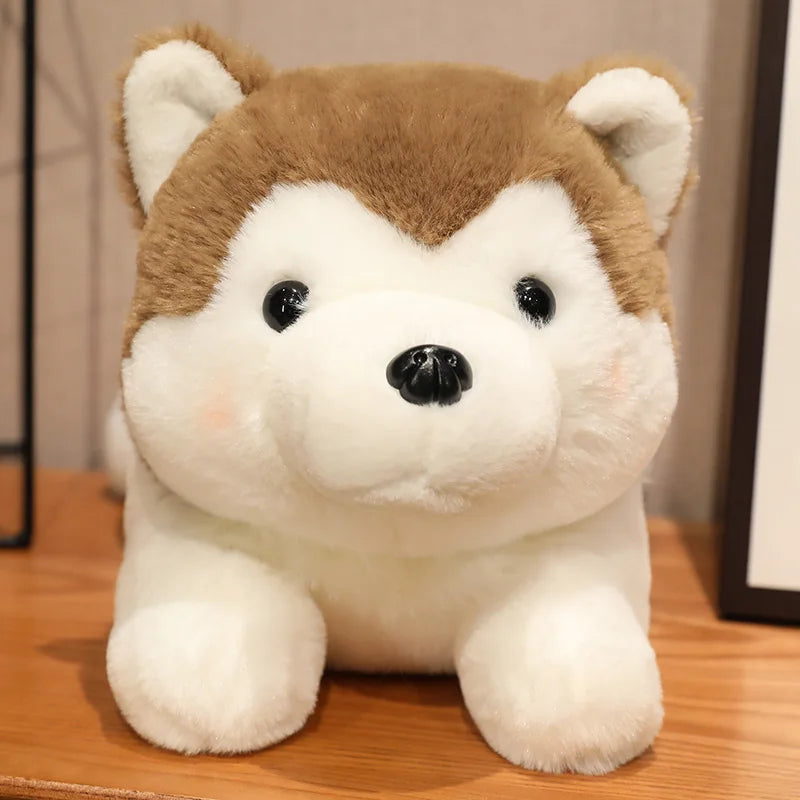 Plush kawaii toy dog with brown and white fur on a wooden surface