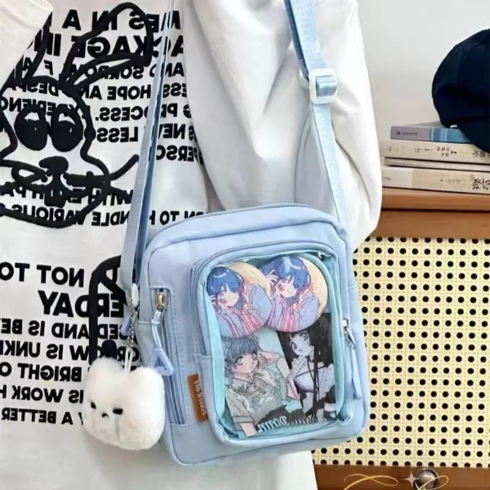 Light blue Kawaii crossbody bag with anime character design on a white surface