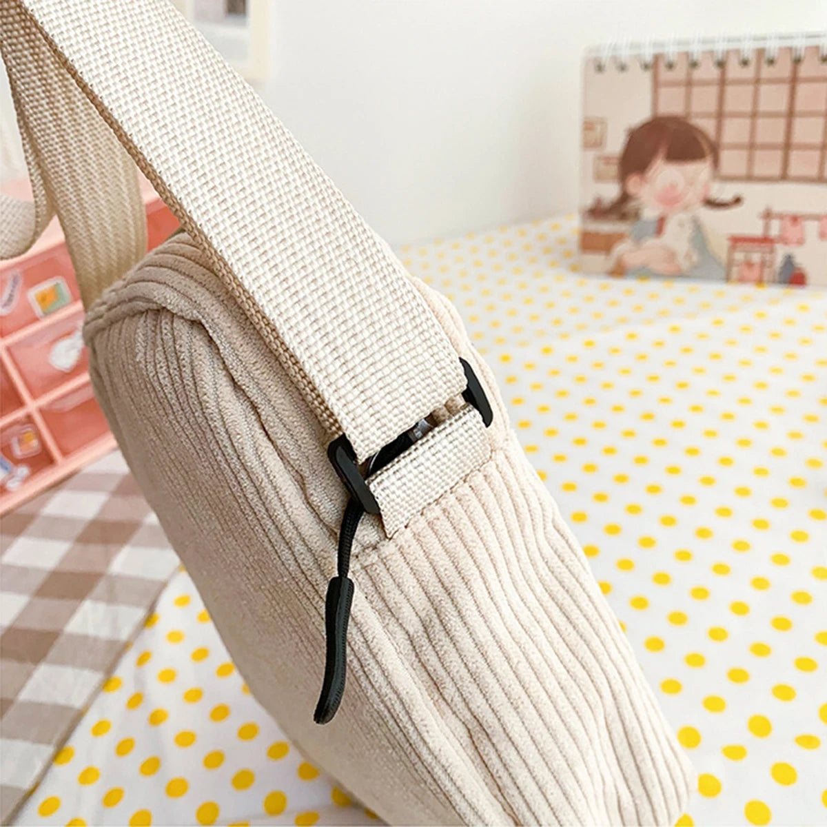 Beige fabric strap with black buckle on a Kawaii polka dot surface