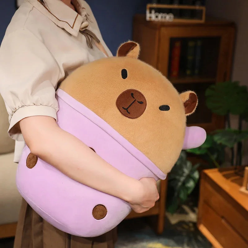 Person holding a large, plush, cartoonish kawaii plushy with a bear face design in a room.