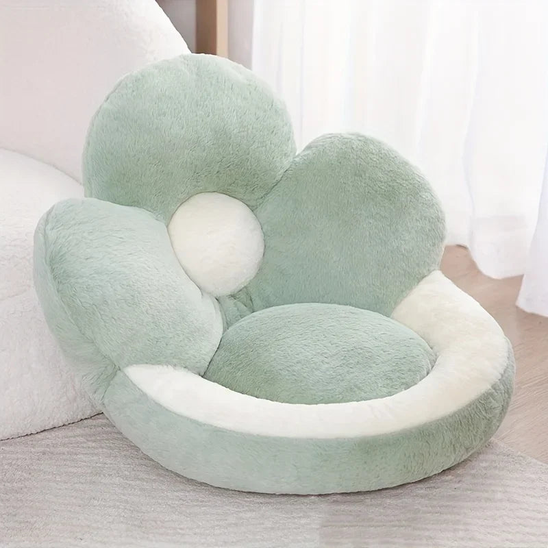 Flower-shaped kawaii pillow in light green on a bed