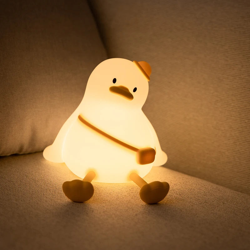 Kawaii chicken-shaped night light on a soft surface with a warm glow