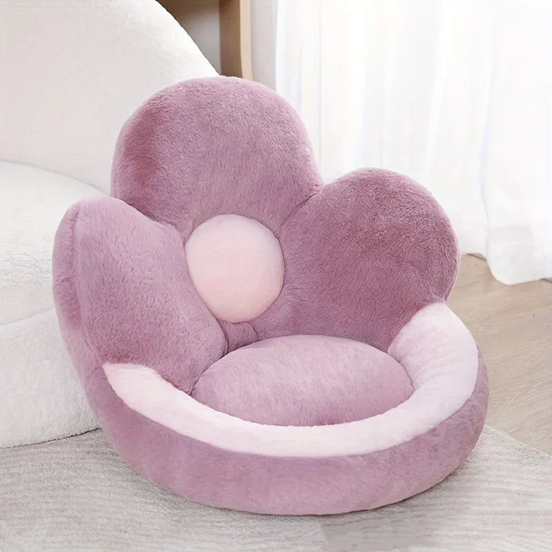 Floral-shaped pink kawaii cushion on a bed with white bedding