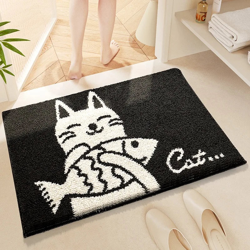 Black doormat with a Kawaii white cat and fish design, placed on a wooden floor.