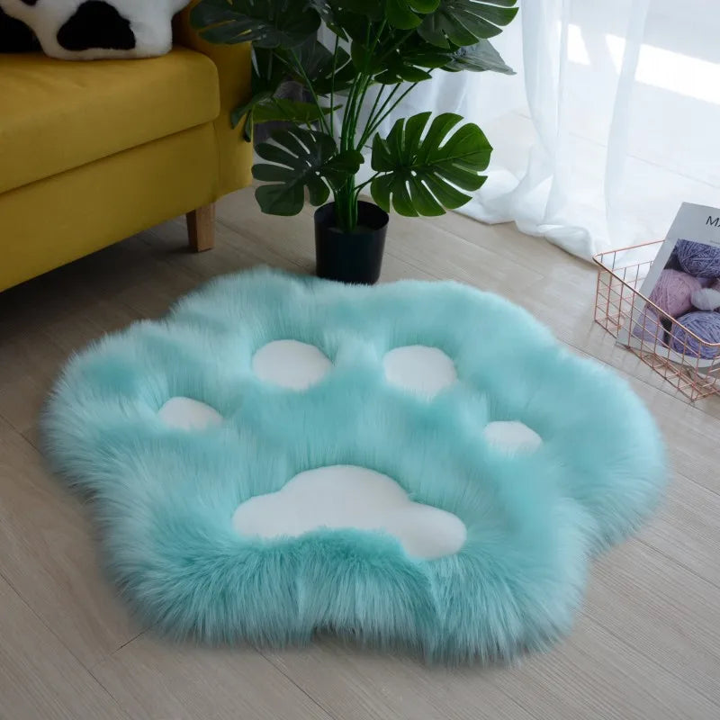 Round kawaii turquoise rug with cloud design on a wooden floor in a living room.