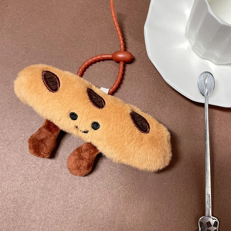 Plush kawaii toy resembling a cookie on a brown surface with a cup and spoon.