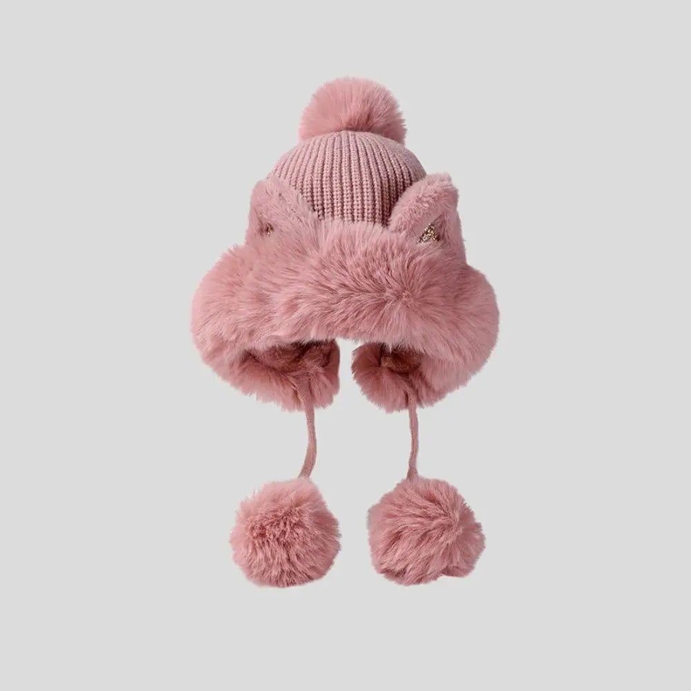 Pink knitted hat with Kawaii fur trim and pom-poms on a light gray background