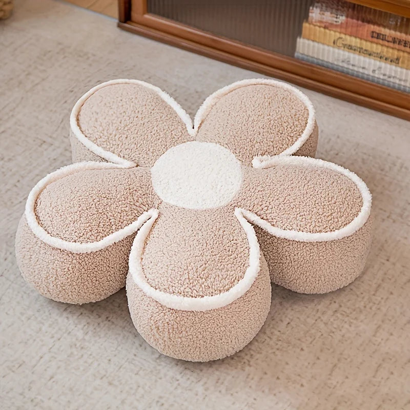 Flower-shaped kawaii cushion with a soft texture on a carpeted floor.