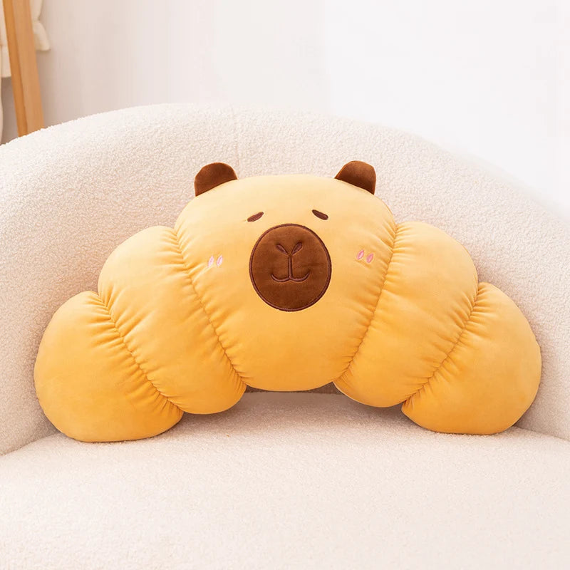 Yellow cloud-shaped kawaii pillow with a bear face on a white couch